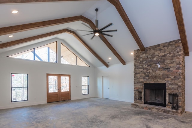 unfurnished living room featuring a ceiling fan, french doors, beamed ceiling, baseboards, and a fireplace