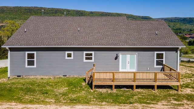 back of property featuring a wooden deck and crawl space
