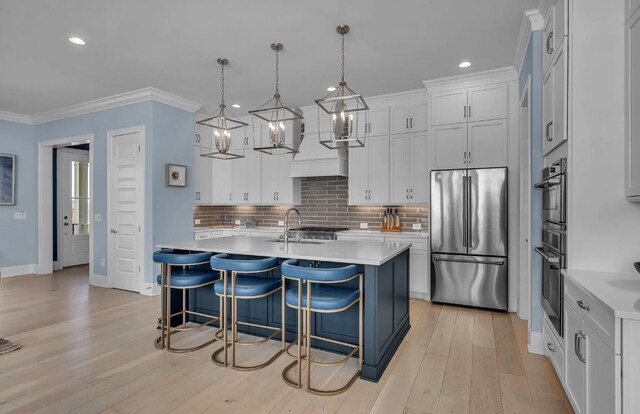 kitchen with a kitchen breakfast bar, high quality fridge, light countertops, backsplash, and ornamental molding