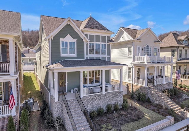 view of front of property featuring a porch, stairs, and a shingled roof