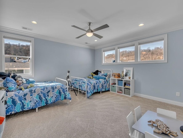 carpeted bedroom with baseboards, visible vents, recessed lighting, a ceiling fan, and crown molding