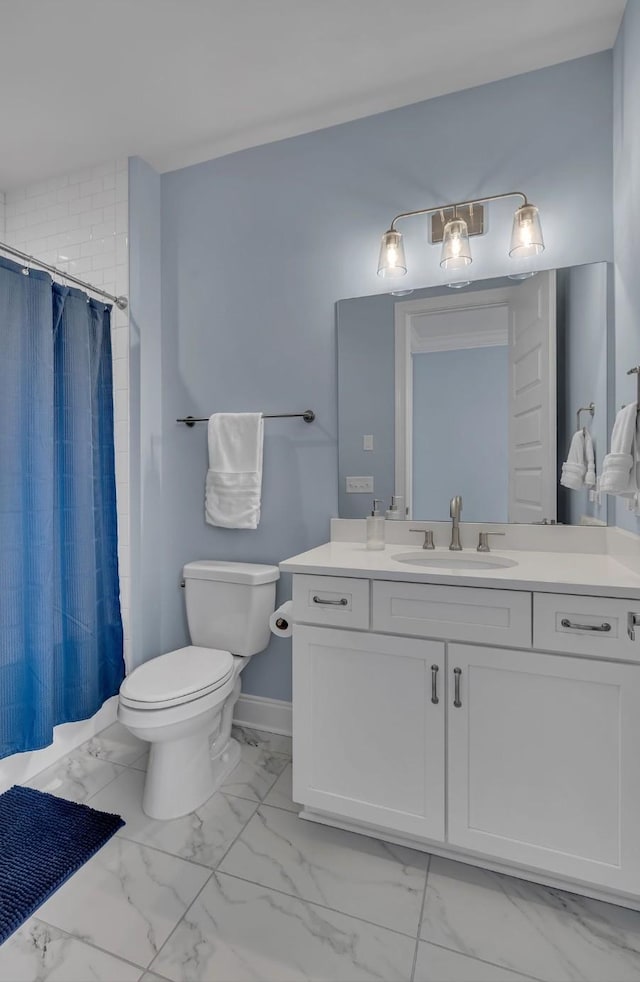 bathroom featuring marble finish floor, toilet, vanity, baseboards, and a shower with shower curtain