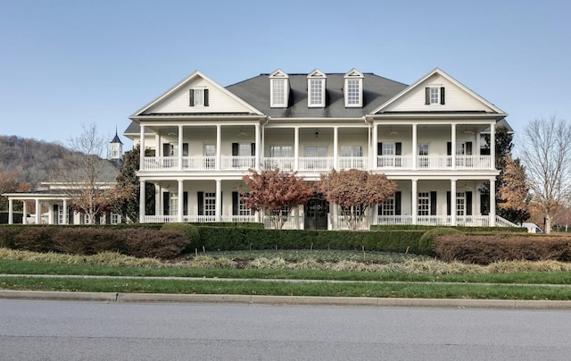 view of front of property with a porch and a balcony