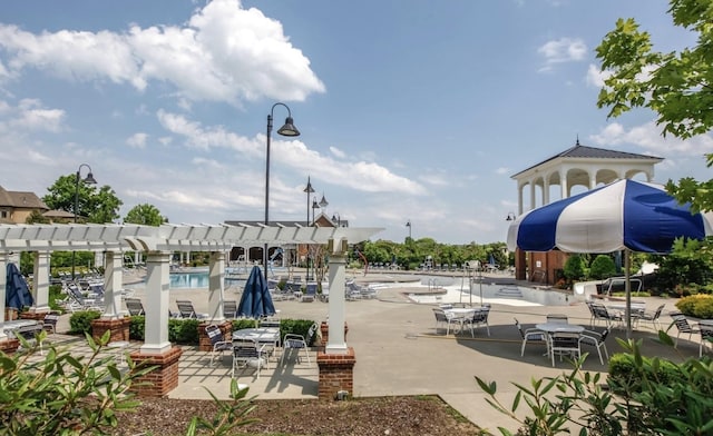 surrounding community with a pergola and a patio area