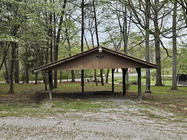 view of home's community with driveway and a carport