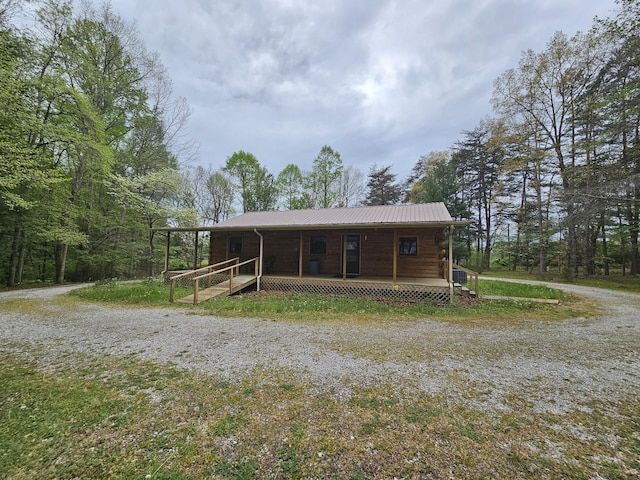 exterior space featuring a porch and metal roof