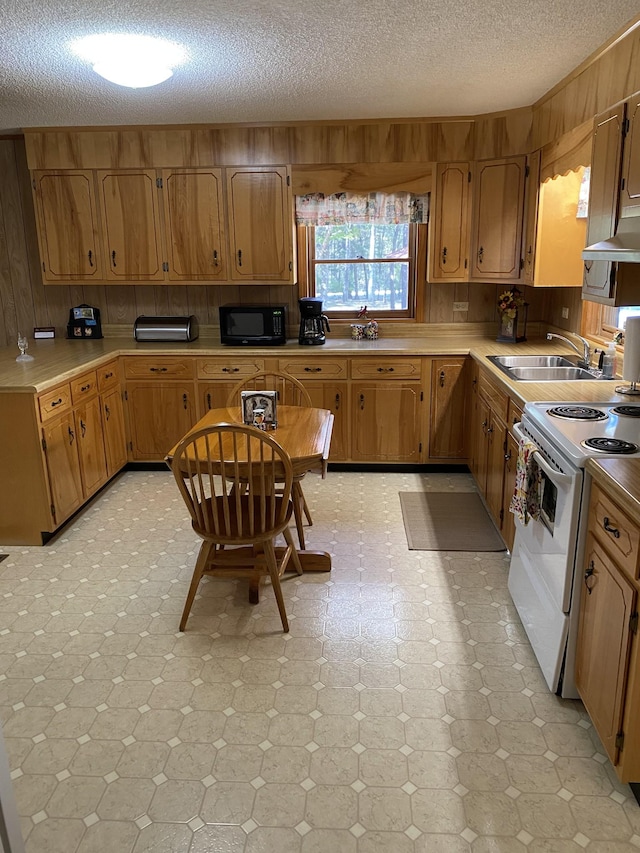 kitchen with electric stove, a sink, a textured ceiling, black microwave, and light floors