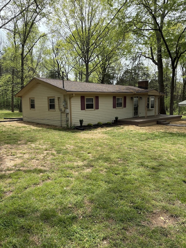 1669 Fellowship Rd, Mount Juliet, TN 37122 - back of property featuring a lawn, a chimney, and a deck