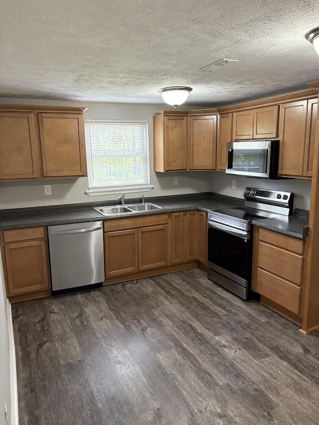 1669 Fellowship Rd, Mount Juliet, TN 37122 - kitchen with brown cabinets, appliances with stainless steel finishes, dark wood-type flooring, and a sink