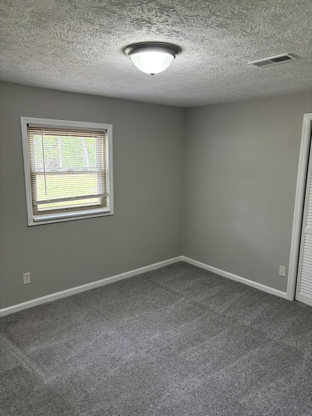 1669 Fellowship Rd, Mount Juliet, TN 37122 - empty room with dark colored carpet, a textured ceiling, and visible vents