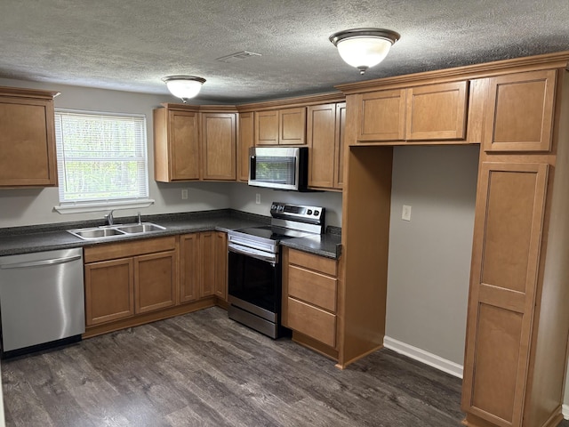 1669 Fellowship Rd, Mount Juliet, TN 37122 - kitchen with brown cabinets, dark countertops, stainless steel appliances, and a sink