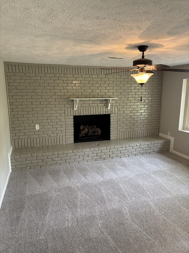 1669 Fellowship Rd, Mount Juliet, TN 37122 - unfurnished living room with a textured ceiling, ceiling fan, carpet floors, a fireplace, and baseboards