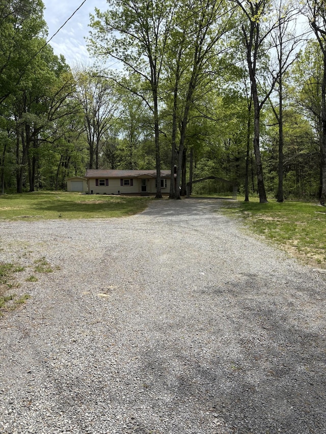 1669 Fellowship Rd, Mount Juliet, TN 37122 - view of front of house featuring a forest view, a front lawn, and driveway