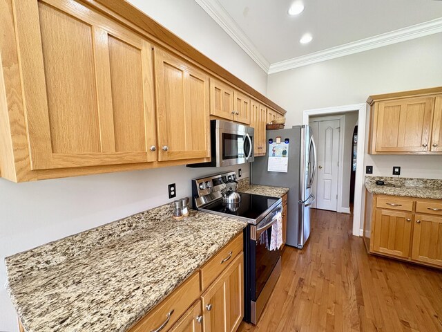 2001 Butler Cv, Lebanon, TN 37087 - kitchen with appliances with stainless steel finishes, crown molding, light wood-style floors, light stone countertops, and recessed lighting