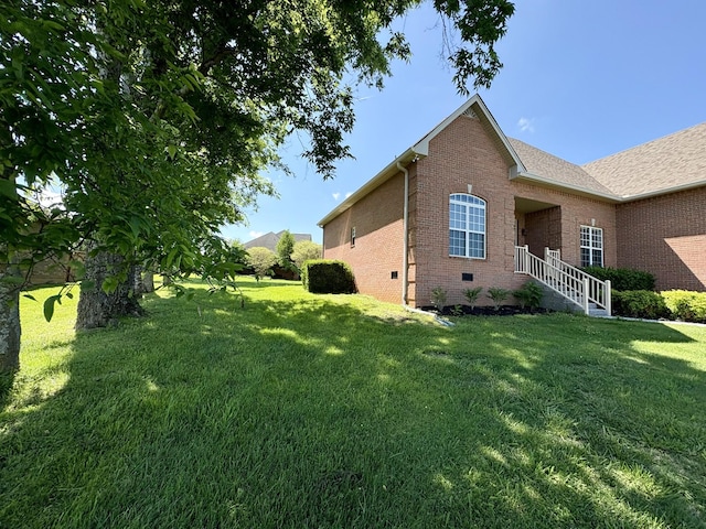 2001 Butler Cv, Lebanon, TN 37087 - view of property exterior featuring brick siding and a lawn