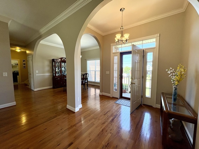 2001 Butler Cv, Lebanon, TN 37087 - entryway featuring crown molding, hardwood / wood-style floors, a chandelier, baseboards, and arched walkways