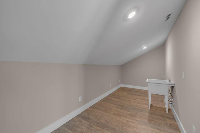 1118 Cotillion Dr, Murfreesboro, TN 37128 - additional living space with a sink, wood finished floors, baseboards, lofted ceiling, and visible vents