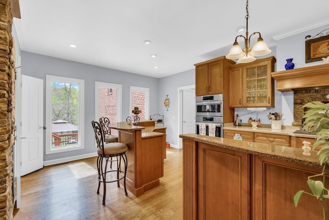 321 Clinchfield Dr, Monterey, TN 38574 - kitchen with a kitchen breakfast bar, brown cabinets, light wood-type flooring, double oven, and glass insert cabinets