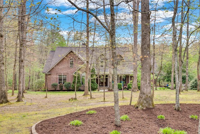 321 Clinchfield Dr, Monterey, TN 38574 - view of front of home with brick siding, roof with shingles, and a front yard