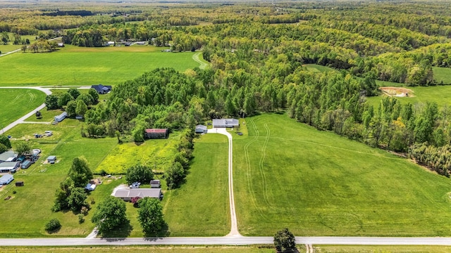 bird's eye view featuring a wooded view and a rural view