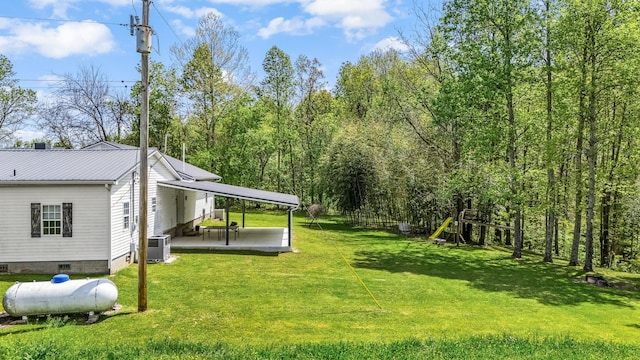 view of yard with a patio area, central AC, and a playground