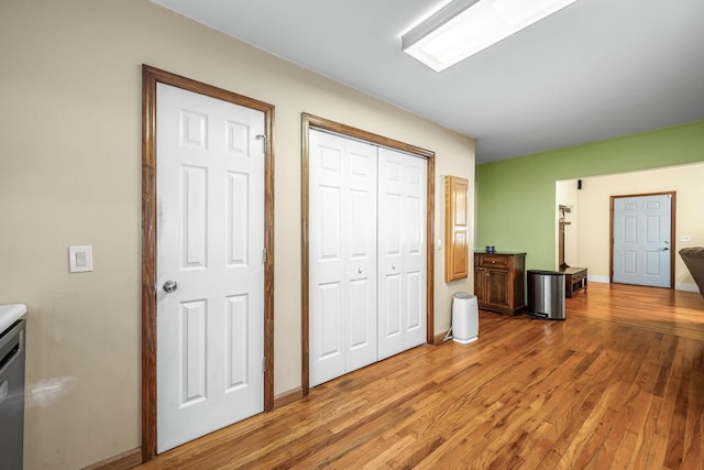 interior space with light wood-style floors, a closet, and baseboards