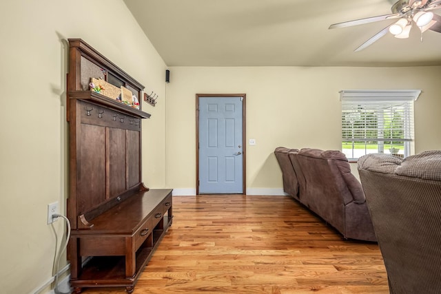 interior space featuring light wood finished floors, a ceiling fan, and baseboards