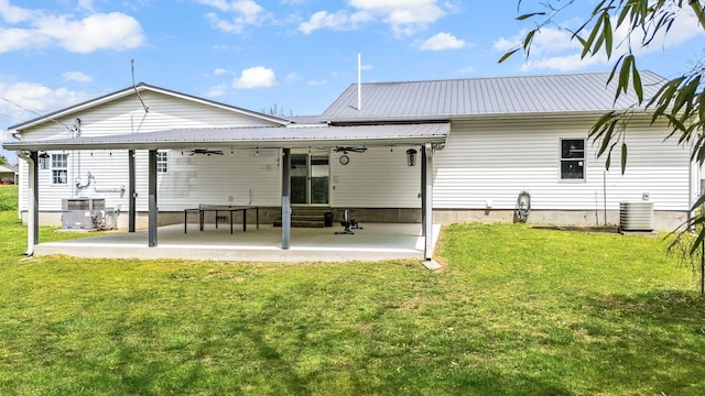back of property featuring a patio, a lawn, cooling unit, and metal roof