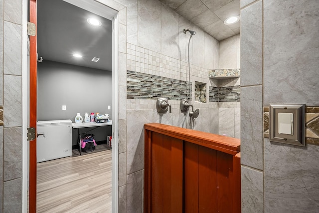 full bath with tile walls, walk in shower, wood finished floors, and recessed lighting