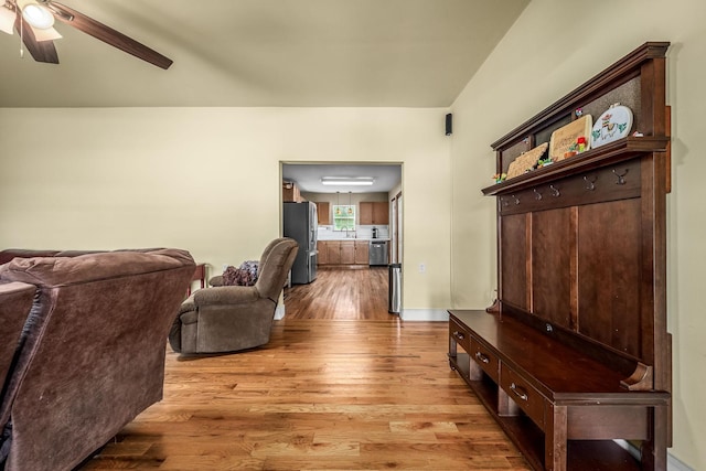 living area with light wood-style flooring and a ceiling fan