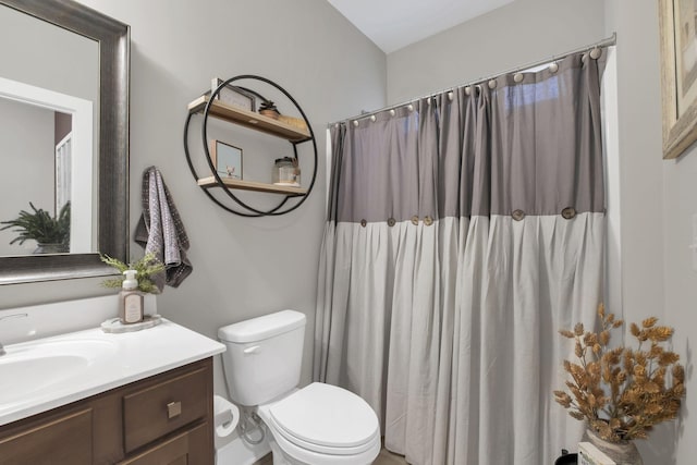 bathroom featuring toilet, a shower with curtain, and vanity