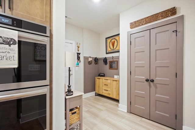 kitchen with baseboards, visible vents, and double oven
