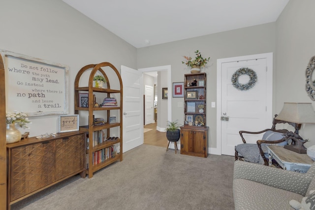 living area featuring carpet flooring and baseboards