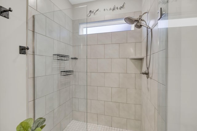 bathroom with tiled shower