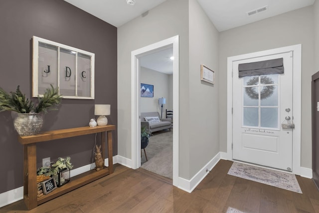 entrance foyer with baseboards, dark wood-style flooring, and visible vents