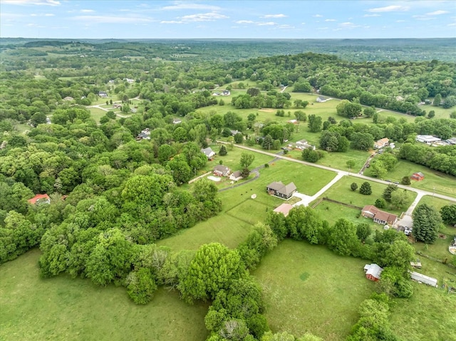 birds eye view of property with a forest view