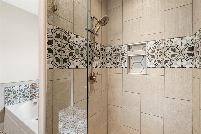 full bath with a tile shower and a bath