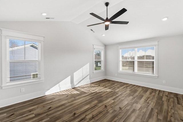 spare room featuring vaulted ceiling, a healthy amount of sunlight, and visible vents