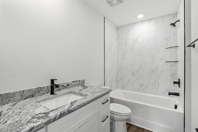 full bathroom with visible vents, toilet, shower / bath combination, wood finished floors, and vanity