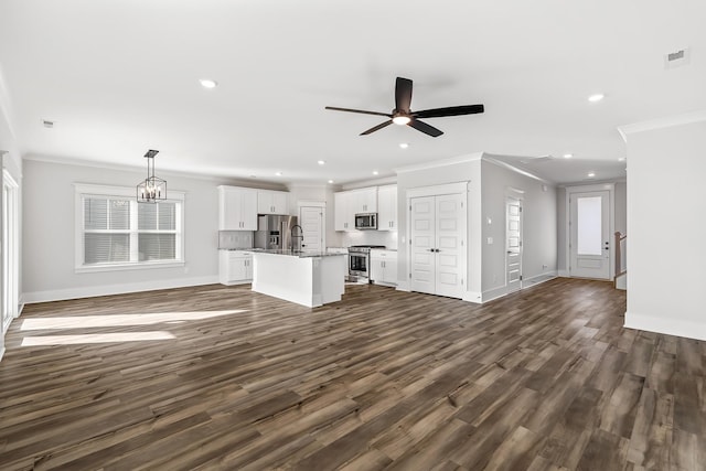 unfurnished living room featuring baseboards, visible vents, recessed lighting, and crown molding