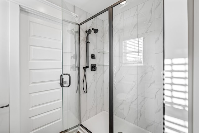 bathroom with a marble finish shower