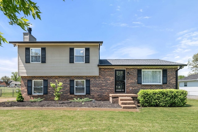 1150 Timberwood Dr, Gallatin, TN 37066 - tri-level home featuring brick siding, fence, a chimney, and a front yard