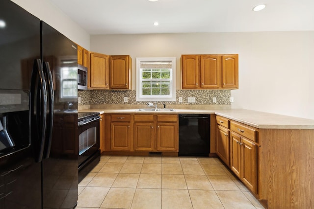 436 Conquest Rd N, Murfreesboro, TN 37128 - kitchen featuring black appliances, a sink, a peninsula, brown cabinetry, and tasteful backsplash