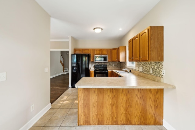 436 Conquest Rd N, Murfreesboro, TN 37128 - kitchen featuring black appliances, a sink, light countertops, and backsplash