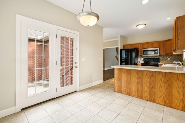 436 Conquest Rd N, Murfreesboro, TN 37128 - kitchen with black appliances, brown cabinets, a sink, light countertops, and backsplash