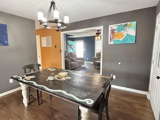 dining room featuring ceiling fan with notable chandelier, baseboards, wood finished floors, and a textured ceiling