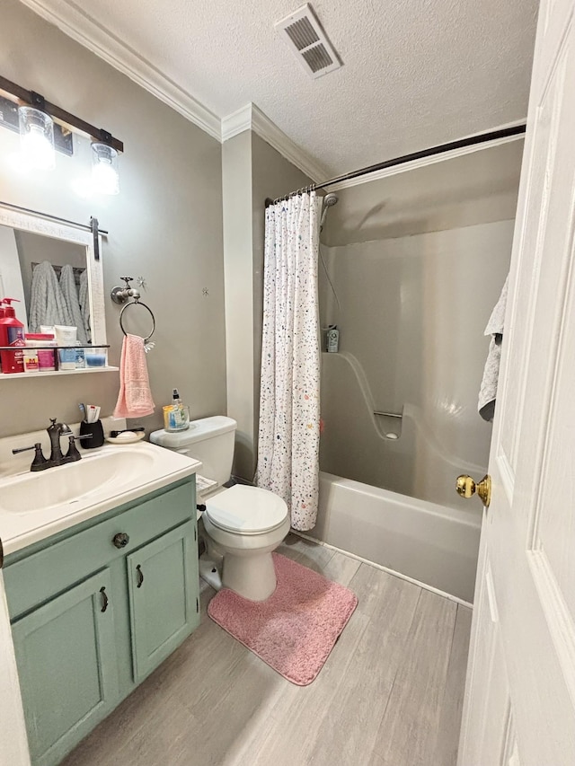 full bathroom featuring toilet, visible vents, wood finished floors, vanity, and ornamental molding