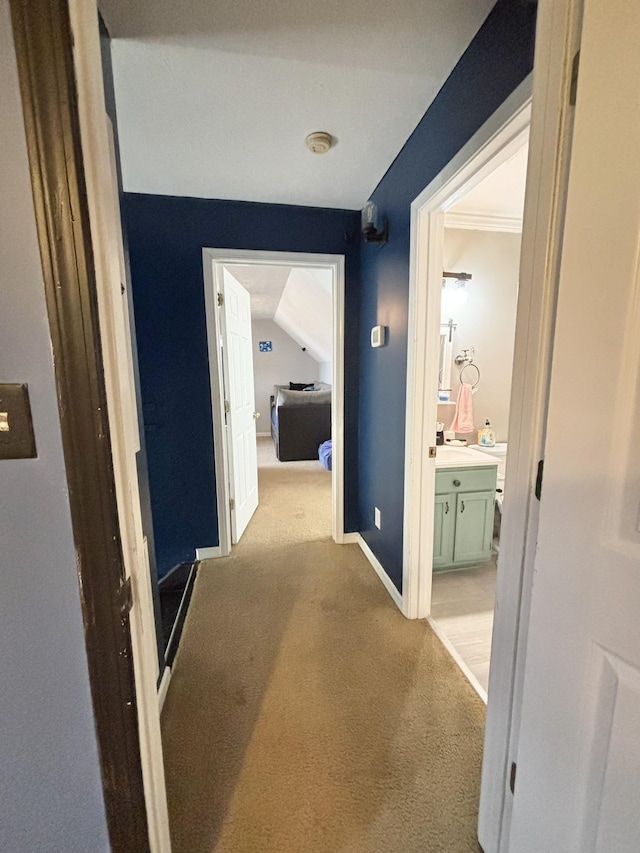 hall with carpet floors and baseboards