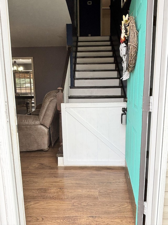 stairway featuring wood finished floors