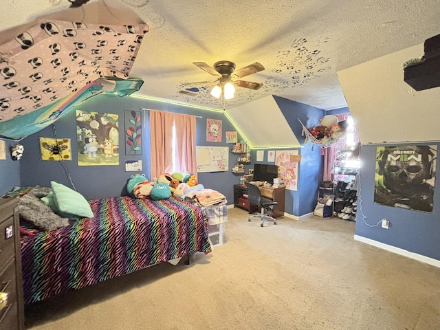 carpeted bedroom with vaulted ceiling, a textured ceiling, a ceiling fan, and baseboards
